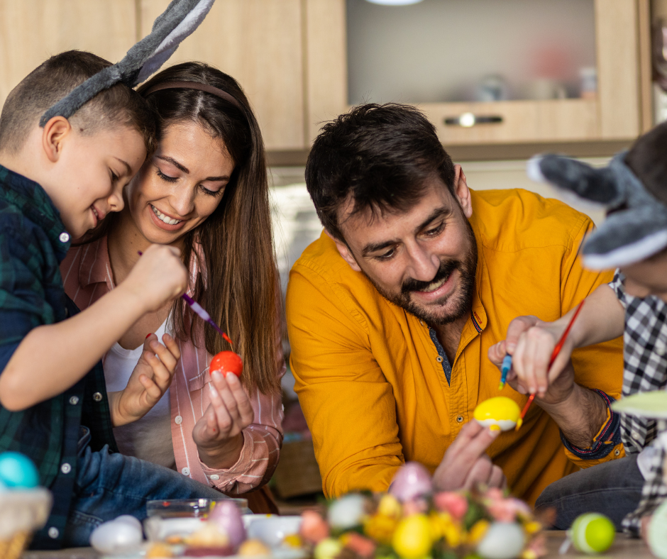 Parent and kids coluring eggs for Easter